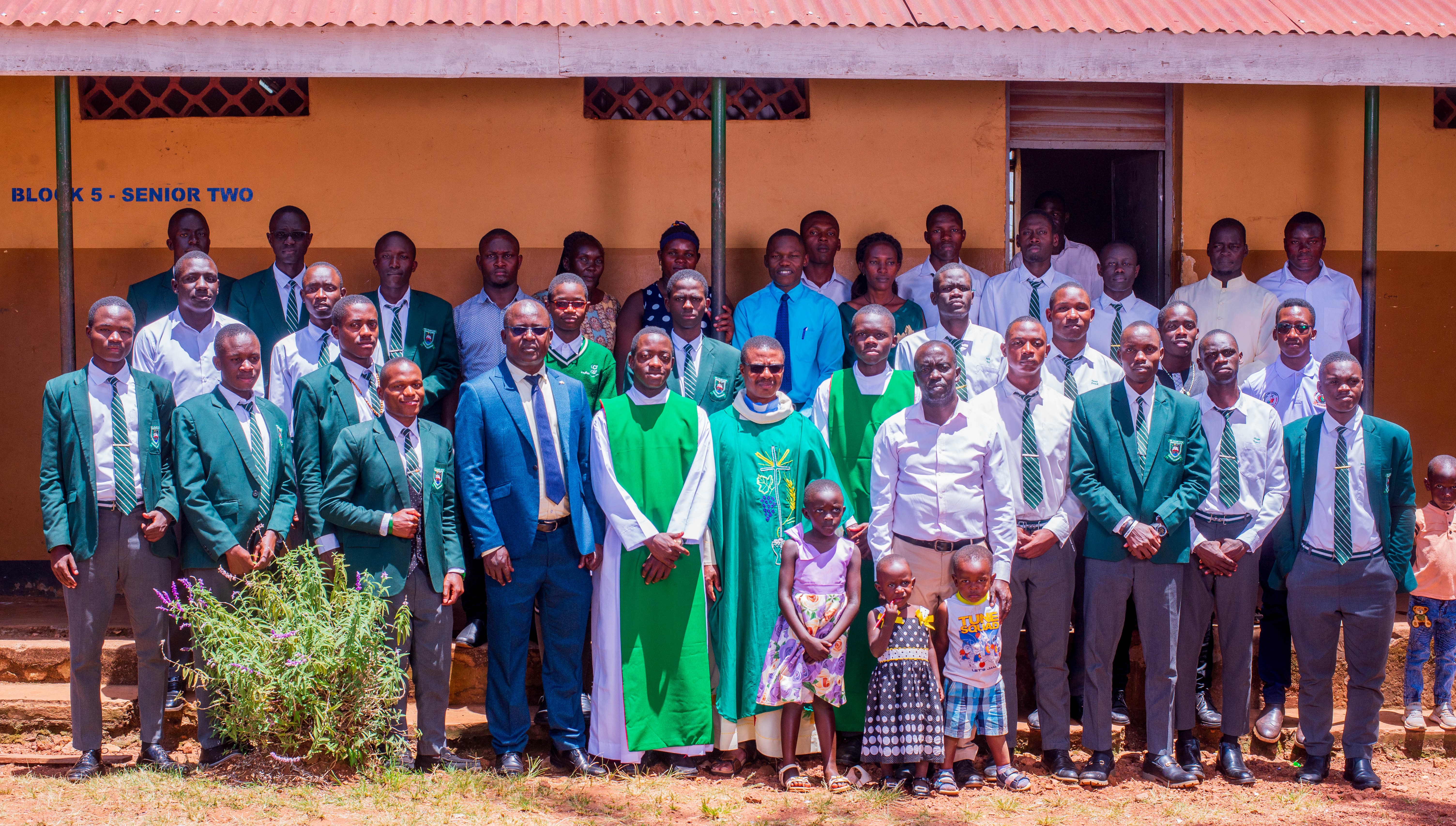 United in Faith and Fellowship: Boys and the Deputy Headteacher share a joyful moment with the clergy after a meaningful church service.